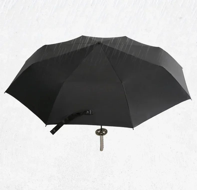 A black folding katana sword umbrella is shown open against a white background.