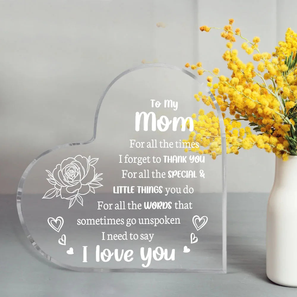 A clear acrylic heart-shaped keepsake engraved with the message I love you Mom for her special and little things.