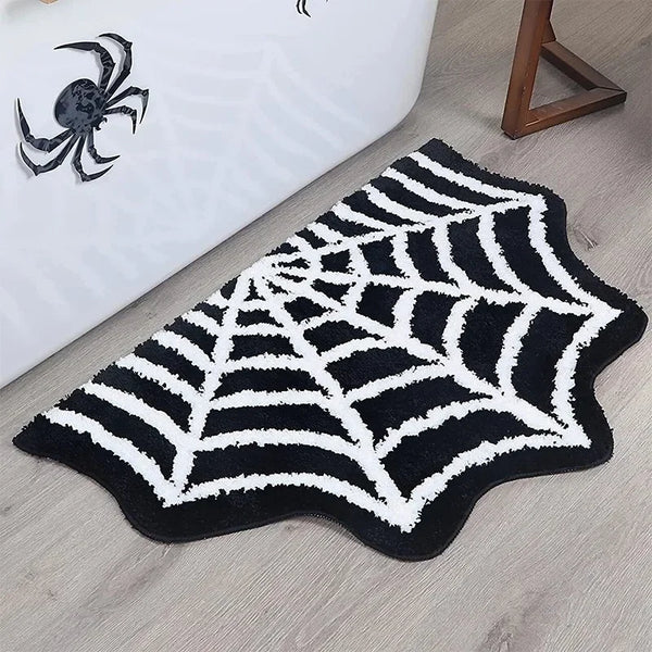 A black and white decorative rug shaped like a spiderweb on a light gray floor.