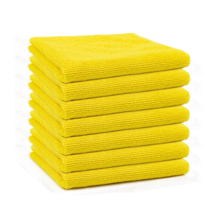 A stack of ten bright yellow reusable microfiber cleaning cloths.