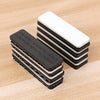 Stack of black and white magnetic curtain clips with strong adhesive backing