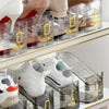 Clear plastic shoe organizer racks displaying various shoes on a shelf.