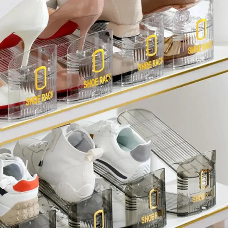 Clear plastic shoe organizer racks displaying various shoes on a shelf.