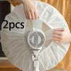 Hands are removing a white protective cover from an electric fan.