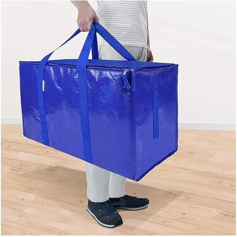 A bright blue heavy duty extra large moving bag with handles is shown standing on a wooden floor.