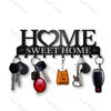 A black rustic metal wall hook key holder featuring a silhouette of a cat and the words Sweet Home.