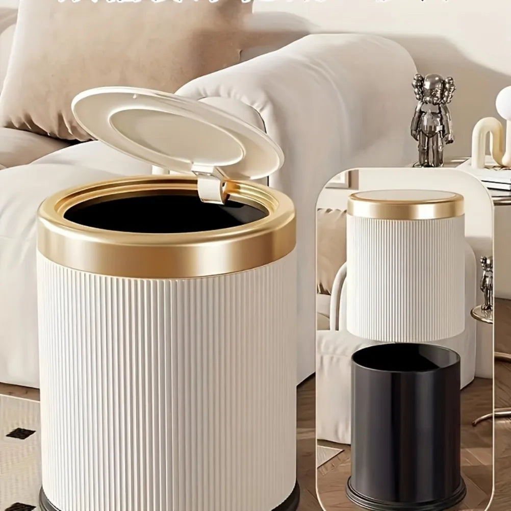 A tall, ribbed trash can with a gold rim and black interior is shown next to a white press-type lid.