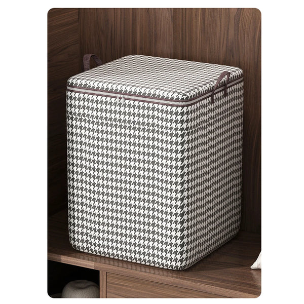 A checkered fabric foldable dustproof clothes storage bag resting inside a wooden shelf.