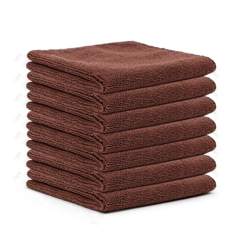 A stack of ten dark brown reusable microfiber cleaning cloths.