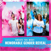 A group of women celebrating with vibrant pink and blue color powder during a gender reveal event.