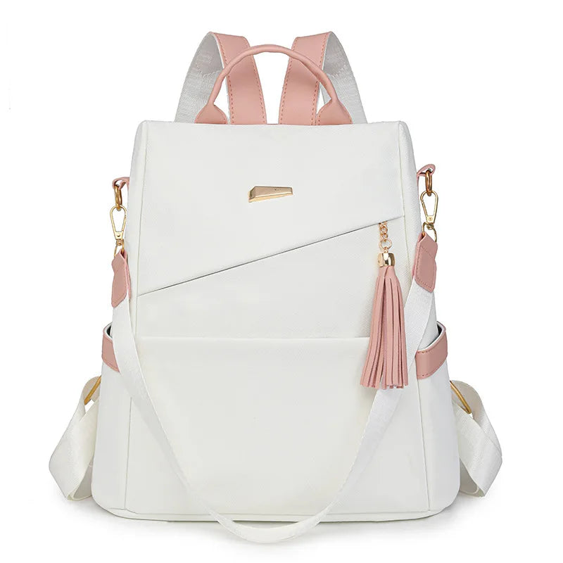 A white women's anti-theft PU leather travel backpack with pink accents and gold hardware.