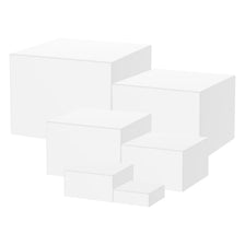 A stack of white acrylic risers used for food display.