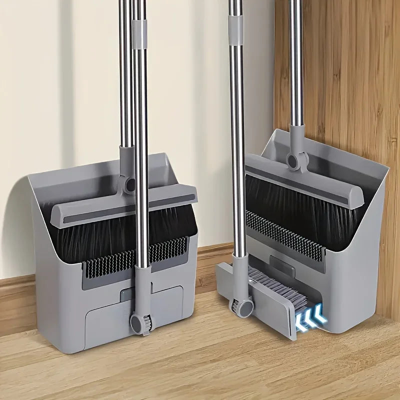 A silver broom and dustpan set with comb teeth for effortless pet hair removal resting on a wooden floor.