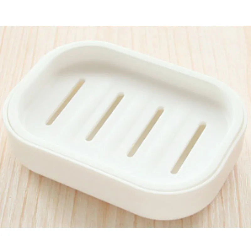 White double layer drain soap dish with three slots for holding soap.