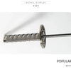 A close-up display of a folding katana sword umbrella with a textured handle and blade.