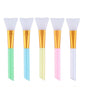A set of six silicone facial mask brushes in various pastel colors, featuring white heads and gold handles.