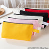 A collection of colorful zipper bags in yellow, pink, white, and black are displayed on a white surface.