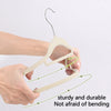 A pair of light beige velvet slim hangers being held by a hand, demonstrating their sturdy and durable bending capability.