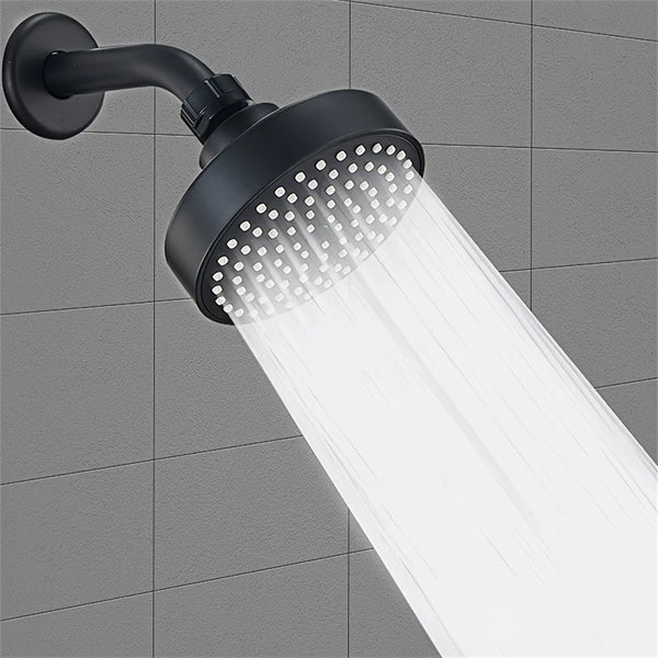 A black bathroom faucet replacement shower head is mounted on a wall, emitting a strong stream of water.