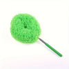 A bright green, spherical microfiber duster with a handle is shown against a white background.