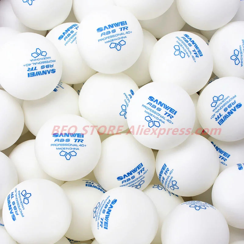 A close-up view of a pack of white Sanwei ABS TR table tennis balls.