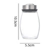 A clear glass spice jar with a stainless steel lid, shown in a side view.