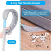 A long flat flexible duster with a telescopic handle is shown cleaning dust from the bottom gaps of furniture.