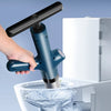 A hand operates a blue drain blaster kit, which is shown dispensing water into a white container.