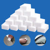 A stack of white magic cleaning sponges used for scrubbing and cleaning tasks.