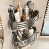 A stainless steel triangular suction cup storage shelf holding various skincare and beauty products.