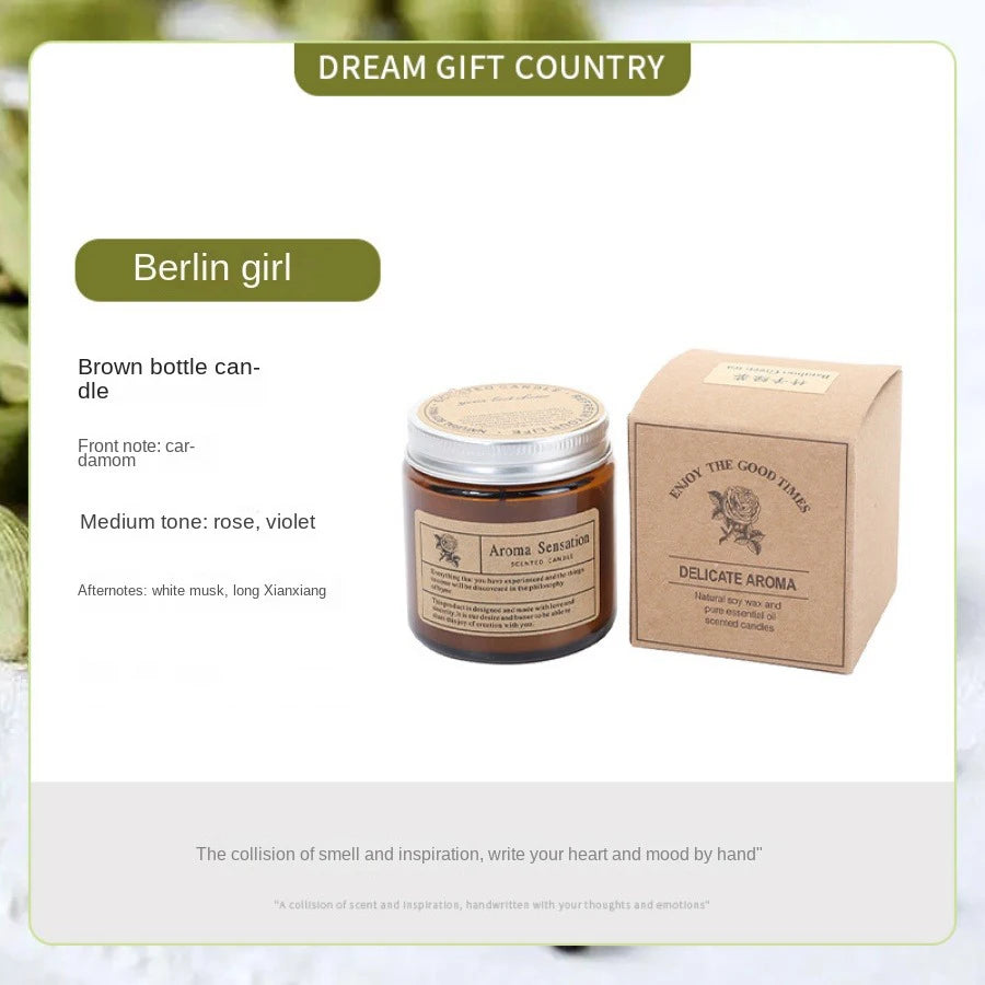 A brown aromatherapy soy wax candle in a glass cup is shown next to its packaging box.