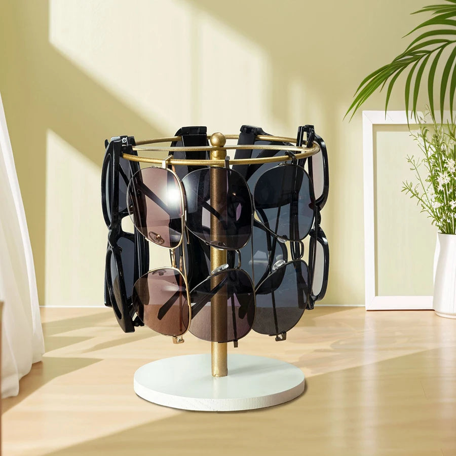 Elegant glasses organizer stand with a gold-toned metal frame and wooden base holding several pairs of sunglasses.