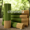 A stack of green citronella oil sticks next to a wooden surface.