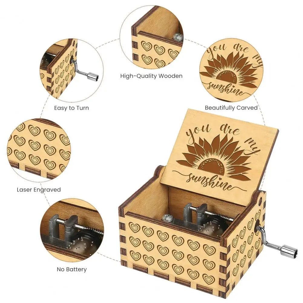 A small wooden music box with a lid featuring a carved sunflower design and a hand crank mechanism.