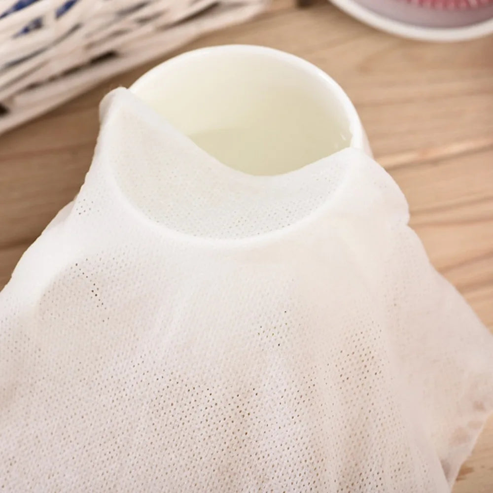 A white disposable compressed travel towel is shown from the top, featuring a mesh texture.