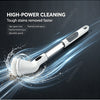 A white cordless electric spin scrubber with a rotating brush cleaning tough stains on a dark surface.