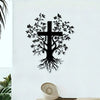 Black silhouette wall art featuring a cross with intricate tree roots and leaves on a white wall.
