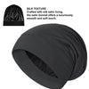 A black satin sleep bonnet is shown, featuring a silky texture and smooth finish.