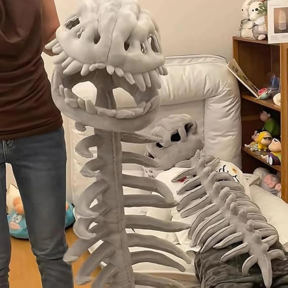 A realistic gray dinosaur skeleton costume displayed on a bed.