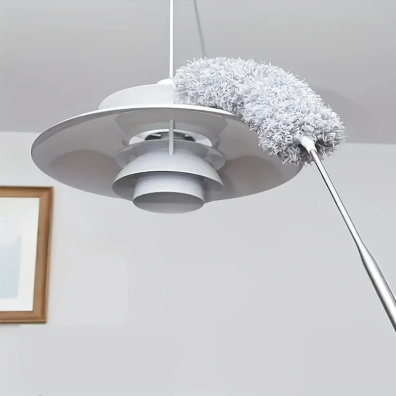 A modern white extendable microfiber duster with a fluffy gray head hanging from a ceiling mount.