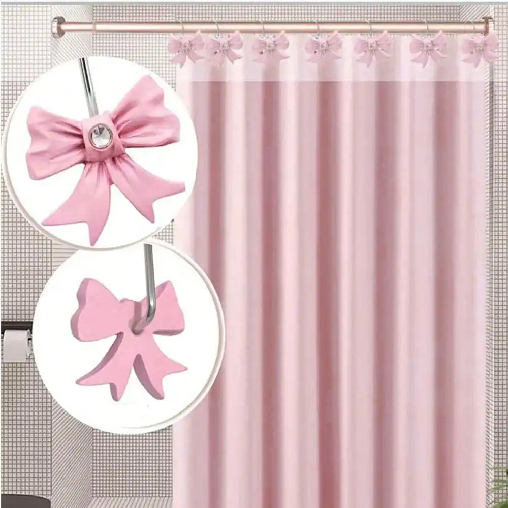 A set of twelve pink decorative bow tie shower curtain hooks hanging from a rod.