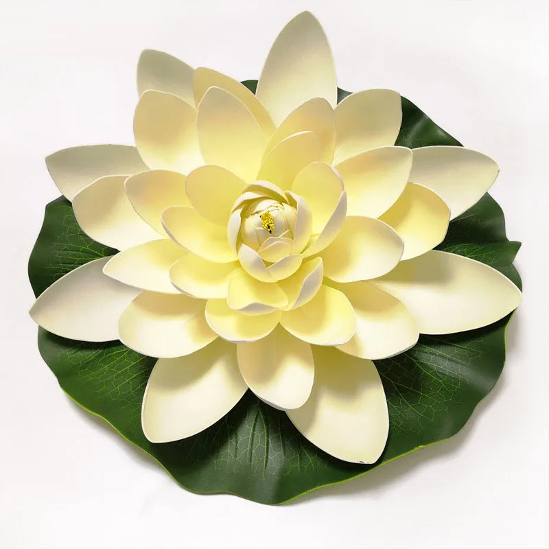 A light yellow artificial lotus flower with green leaves, used for pond and garden decor.
