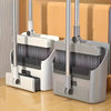 A silver and white broom and dustpan set with comb teeth for pet hair removal resting on a wooden floor.