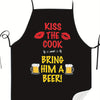 Black apron with red text that reads Kiss the cook and bring him a beer