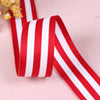Red and white striped grosgrain ribbon rolled for crafting and decorating