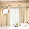 A stainless steel telescoping rod is installed above a window, used to hang a shower curtain.