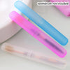Three colored portable toothbrushes in plastic tubes are displayed on a white surface.
