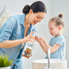 A woman is dispensing Farmhouse Cow Soap into a child's hands in a kitchen setting.