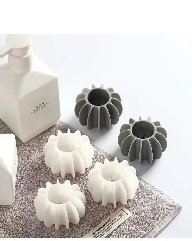 A set of reusable laundry balls in white and gray for pet hair and lint removal
