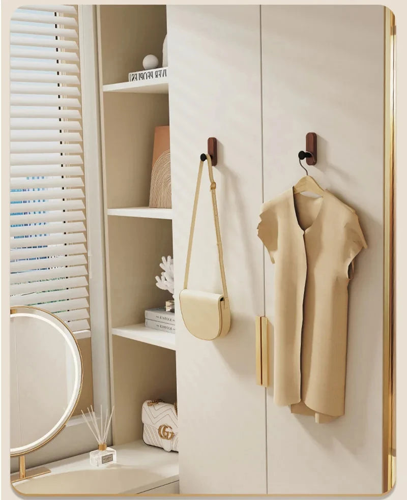 A light beige jacket is hanging on a wall hook in a modern bathroom or closet setting.